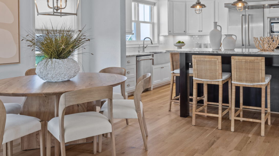 Virginia Beach condo dining room and kitchen beautifully staged with modern, neutral art and furniture by Impressive Home Staging